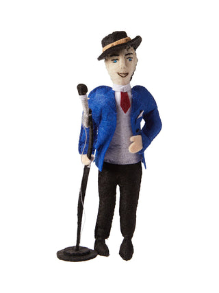A felt ornament depicting Frank Sinatra in a fedora hat and blue sport and red tie, holding a microphone on a stand.