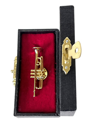 A lapel pin that looks like a gold trumpet, in a red, velvet-lined case.