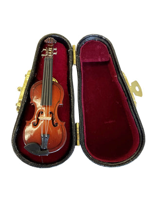 A lapel pin that looks like a violin, in a red, velvet-lined case.