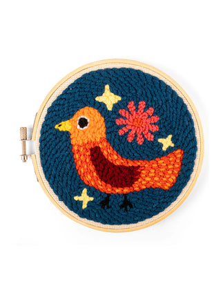 A finished punch needle kit in a wooden embroidery hoop depicting an orange bird.