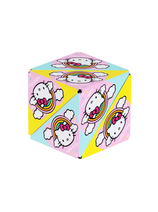 A pink, blue, and yellow puzzle box toy with Hello Kitty's face under a rainbow.