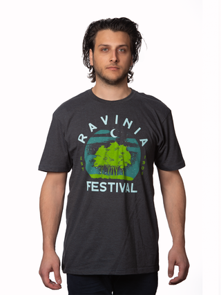 A young man wearing a t-shirt that reads, Ravinia Festival, with a rendition of moon over green trees.
