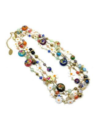 A long multicolored glass bead necklace with flowers, looped multiple times, on a white background.