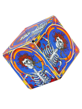 A cube featuring the Grateful Dead's skull with roses design, in blue, orange and red.