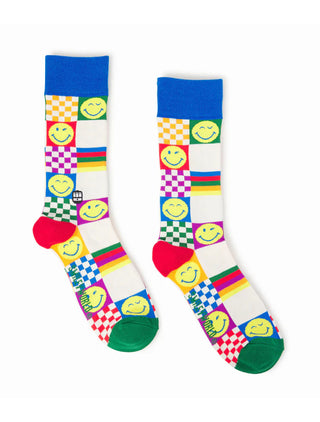 A flat pair of socks with smiley faces and colorful rainbow checker designs.