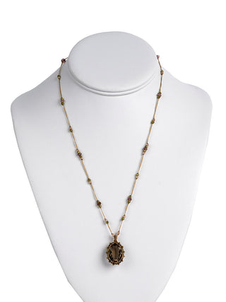 The smoky quartz necklace on a model neck.