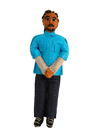 A felt ornament depicting rapper Snoop Dogg, who is dressed in a blue shirt and baclk pants.