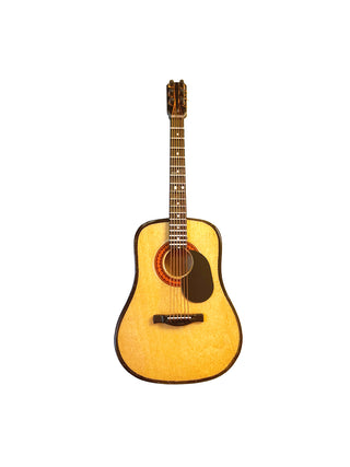 A magnet of a classical guitar with a ick guard.