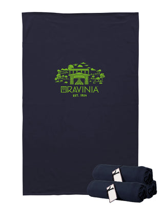 A rectangular navy blanket with the words RAVINIA EST. 1904 in green, below a green scene featuring the park's Tyler Gate.