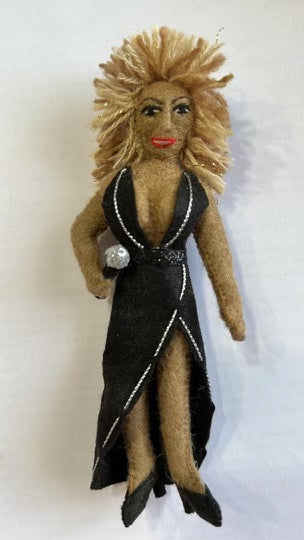 A felt ornament depicting Tina Turner in a black dress, complete with microphone.