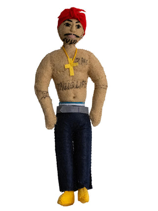 A felt ornament depicting the late rapper Tupac Shakur, complete with gold cross and "thug life" tattoo.