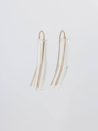 A pair of brass hook earrings, largely enclosed in tubes of clear glass.