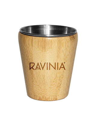 A shot glass with stainless steel on the inside and bamboo on the outside, featuring the word Ravinia.