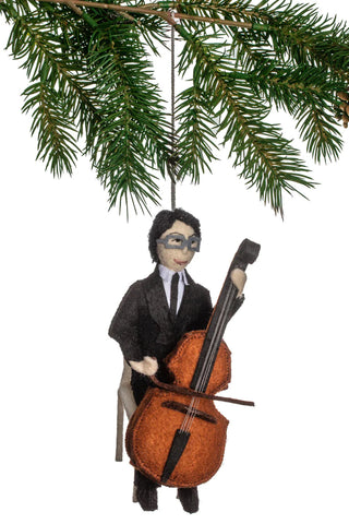 A felt ornament depicting Yo Yo Ma playing the cello, with a Christmas tree branch above.