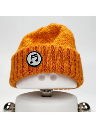 A Marmal figure wearing an orange beanie with a music note pin.