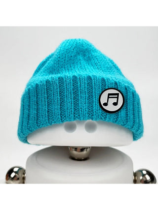 A Marmal figure wearing a light blue beanie with a music note pin.