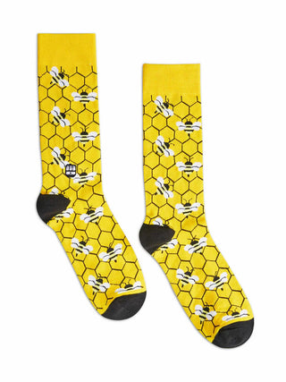 Yellow and black socks with a honeycomb pattern and bees.
