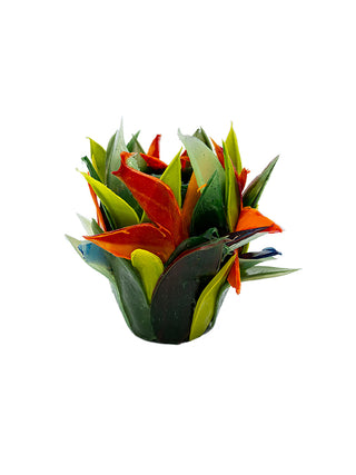 A handmade silicone vase that resembles an orange bird of paradise flower with large green leaves.