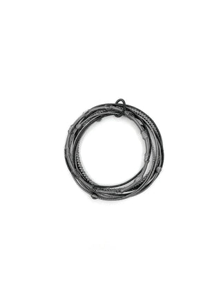 A set of gray and black bracelets made of textured piano wire.