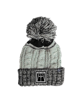A black and grey knit beanie with a pompom on the top and the Ravinia logo on the brim.