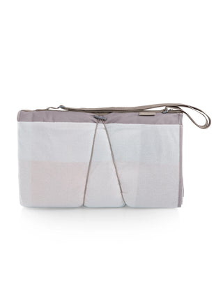 The back of the rolled blanket tote, showing the pastel beige plaid pattern of the fleece.