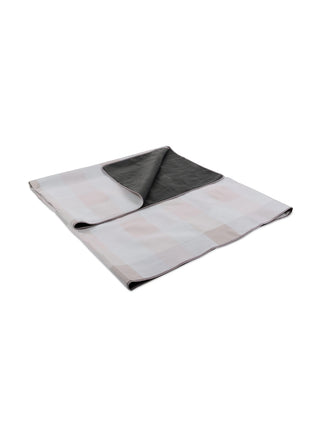 The blanket tote folded to show both the plaid fleece topside and the waterproof underside.