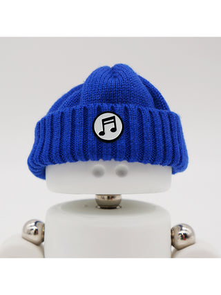A Marmal figure wearing a blue beanie with a music note pin.