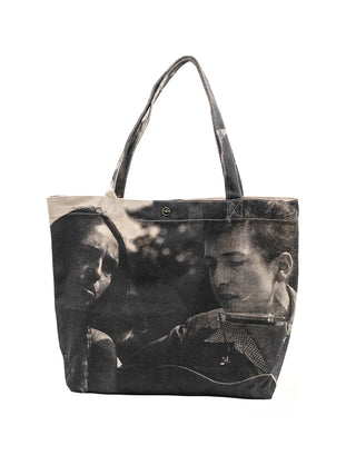 A canvas tote bag with a screenprint design of Bob Dylan and Joan Baez.