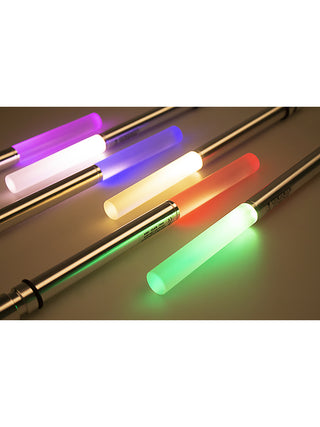 Six bottlelight lamps laying on a table, displaying different colors.