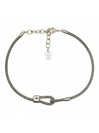 Overhead view of a silver bracelet made from a bass guitar string.