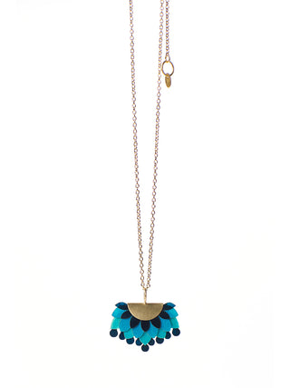 A brass chain necklace with a blue and gold pendant made of drum leather.
