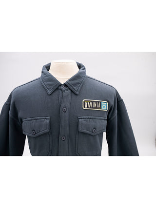 A closeup of the embroidered patch on the left with the Ravinia logo.
