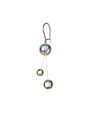 A wire earring with three iridescent crystal pearls hanging on nylon threads.