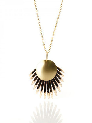 A brass chain necklace with a black pendant made of drum leather.