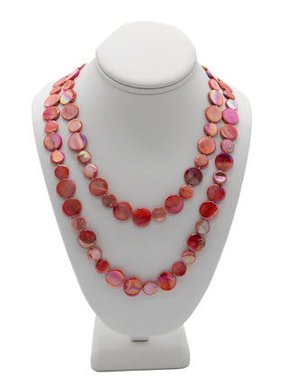 A doubled necklace made of red mother of pearl disc beads on a white neck display.