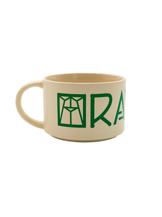 A cream colored wide soup mug with the Ravinia logo in green.