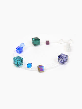 A bracelet made of square multicolored crystals on transparent nylon thread.