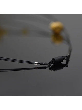 A close-up image of the black magnetic clasp of the necklace.