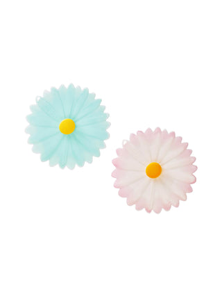 Two silicone drink covers in the shape of a blue and pink daisy.