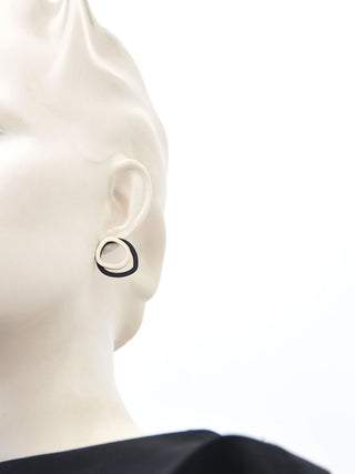 Stud earrings made up of a gold ring and a larger black ring.