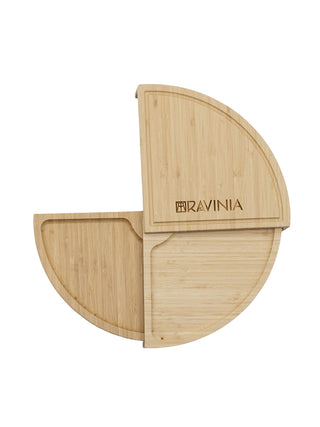 A Ravinia branded bamboo cheese board in the shape of 3/4 of a circle.