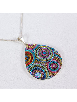 A bedazzled teardrop pendant on a silver chain.