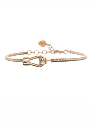 A bracelet made from a bass string dipped in gold, with a heart at its back.