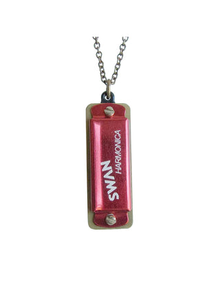 A red miniature functional harmonica on a chain that reads Swan Harmonica.