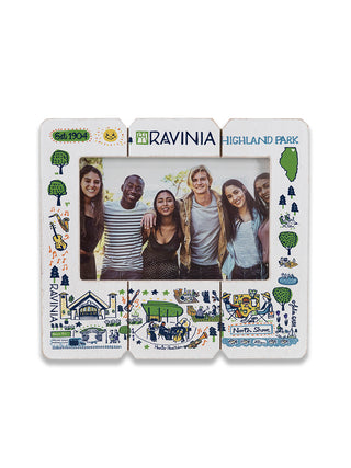 A white wooden picture frame with a Ravinia graphic design, displaying a picture of friends.