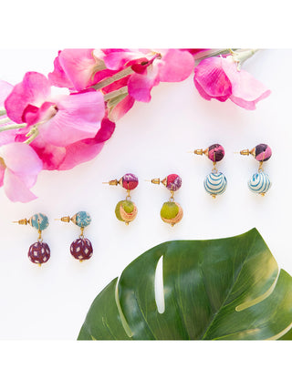 Three pairs of post earrings made of two wooden beads wrapped in colorful Kantha fabrics.