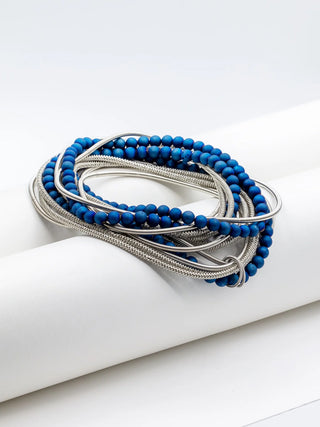 A piano wire necklace with geode beads, looped, on a white background.