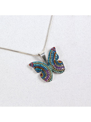 A bedazzled pendant in the shape of a butterfly on a silver chain.