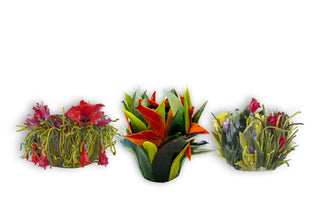 Three silicone vases that look like plants and flowers, on a white background.