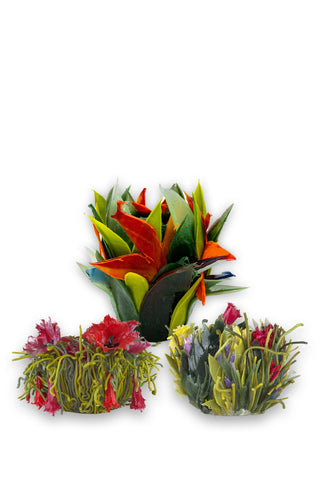 Three silicone vases that look like plants and flowers, on a white background.